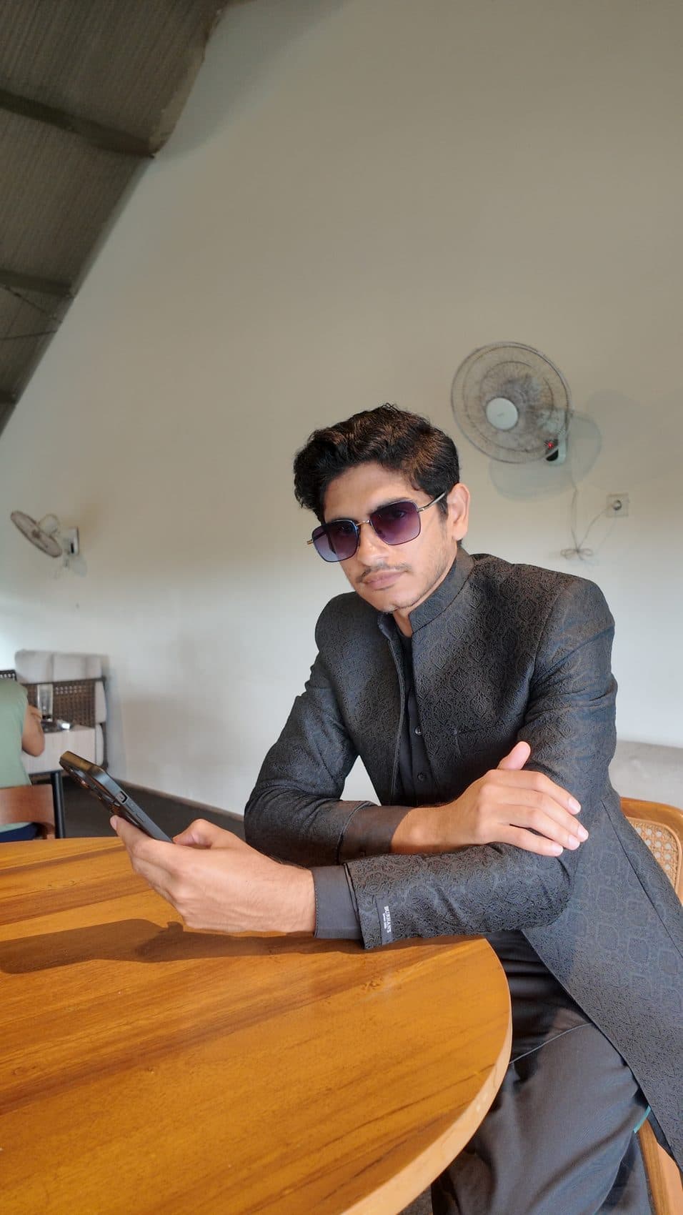 Waseem Nasir — confident founder portrait, arms crossed in sunglasses